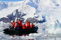 Tourists taking pictures on a zodiac boat ride, Neko Harbor, Andvord Bay, Antarctica, February 2011.