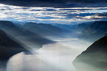 Lysefjorden viewed from the Preikestolen (Pulpit rock) on misty summer morning with sun rays shining down, Forsand, Rogaland, Norway.