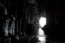 View looking out past columnar basalt from inside Fingal's Cave. Staffa, Inner Hebrides, Scotland. July.