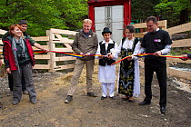 Frans Schepers from Rewilding Europe, two village children and Armenis Mayor Petru Vela performing the official ribbon-cutting ceremony at the release of European bison / Wisent (Bison bonasus) in the...