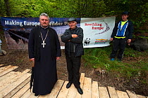 Armenis priest and villagers at the release of European bison / Wisent (Bison bonasus) in the Tarcu mountains nature reserve. The priest held a sermon for the bison and splashed them with Holy water....