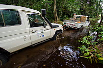 African Parks truck towing another vehicle through water, Mbomo, Odzala-Kokoua National Park, Republic of Congo (Congo-Brazzaville), Africa, May 2013.