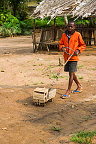 Boy with wooden toy truck. Mbomo Village, Odzala-Kokoua National Park, Republic of Congo (Congo-Brazzaville), Africa, May 2013.