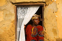 Local woman in doorway, Mbomo Village, Odzala-Kokoua National Park, Republic of Congo (Congo-Brazzaville), Africa, May 2013.