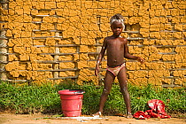 Local child washing in Mbomo Village, Odzala-Kokoua National Park, Republic of Congo (Congo-Brazzaville), Africa, May 2013.