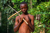 Boy with homemade crossbow used to shoot rats. Mbomo, Odzala-Kokoua National Park, Republic of Congo (Congo-Brazzaville), Africa, June 2013.