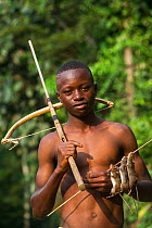 Boy with homemade crossbow used to shoot rats. Mbomo, Odzala-Kokoua National Park, Republic of Congo (Congo-Brazzaville), Africa, June 2013.