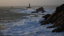 Winter storm at the Pointe du Raz in Finistere, with the Vieille Lighthouse in the background, Brittany, France, January 2014