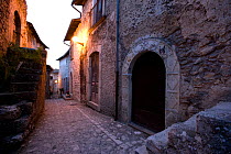 Narrow alley between stone houses, Santo Stefano di Sessanio, Abruzzo, Italy, May 2006.