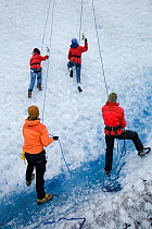Climbers on ice wall, Mendenhall Glacier, near Juneau, Alaska, North Pacific Ocean.
