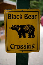 Black bear crossing warning sign, Juneau, Alaska, United States.