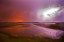 Lightning at midnight over Arnold's Marsh, Cley, Norfolk, UK, July 2014.