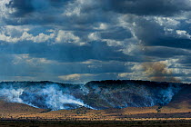 Bushfires in dry season on the Isuria escarpment, Masai-Mara Game Reserve, Kenya. October 2007.