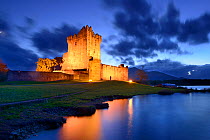 Ross Castle lit up at twilight, Killarney National Park, County Kerry, Republic of Ireland. November 2013.