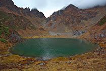 Small lake in mountain landscape, Mount Kawakarpo, Meili Snow Mountain National Park, Yunnan Province, China. October 2009