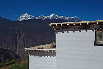 Traditionally built house painted white, Mount Kawakarpo, Meili Snow Mountain National Park, Qinghai-Tibet Plateau, Yunnan Province, China. October 2009