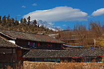 Houses in village near Lashihai lake with mountain in background, Lijiang City, Yunnan Province, China. January 2012