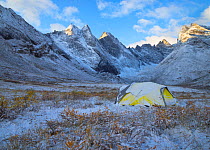 Tent covered in snow, below peaks of Arrigetch Peaks, Brooks Range, Gates of the Arctic National Park, Alaska, USA, September 2014.