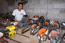 Sayan Raksachart of Freeland Foundation, with confiscated outboard motors and chainsaws used by Siam rosewood tree poachers, Thap Lan National Park, Dong Phayayen-Khao Yai Forest Complex, eastern Thai...