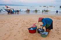 Fishermen and buyers on the beach, Bali, Indonesia, August 2014.