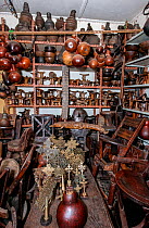 Interior of a toursit shop in Addis Ababa featuring various items such as Coptic crosses, headrests, bottle gourds, wooden chairs, a stuffed crocodile and various wood carvings, which the seller claim...