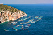 Fish farming sea cages at Selonda Bay / Korfos Bay, Aegean Sea,  Peloponnese, Greece. August 2007