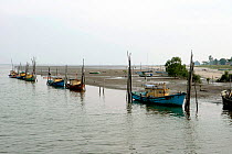 Traditional Malaysian fishing boats on the banks of Kuantan River, Kuantan, Malaysia. September 2007.
