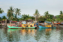 Traditional Malaysian fishing boats on the banks of Kuantan River, Kuantan, Malaysia. September 2007.