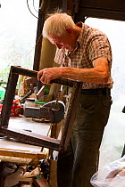 Beekeeper making frames for honey bees, Usk, Gwent, Wales, UK. August 2014.