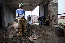 Economic migrant from rural areas working on construction site, Nairobi, Kenya, November 2013.