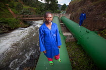 Technicians inspecting pipes carrying water to hydro electric power plant, Rwanda, September 2014.