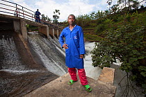 Technicians standing in front of hydro electric power plant, Rwanda, September 2014.
