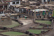 Traditionally built houses and dry stone walls, Makalu Mountain, Mount Qomolangma National Park, Dingjie County, Tibet, China, May 2013.
