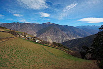 Village on mountainside, Kawakarpo Mountain, Meri Snow Mountain National Park, Yunnan Province, China, January 2014.