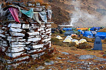 Mani wall or chorten and Camp Jangothang on the Jhomolhari Trek. Bhutan, October 2014.