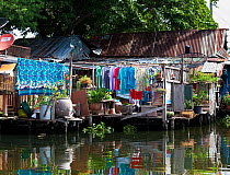 Laundry hanging to dry outside homes along the Khlong Bangkok Yai (canal), Bangkok. Thailand, September 2014.