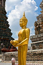 Golden Buddha statue with alms bowl, Wat Arun, Bangkok. Thailand, September 2014.