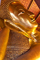Golden statue of the reclining Buddha at Wat Pho in Bangkok. Thailand, September 2014.