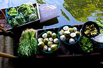 Boat loaded with fruit and vegetables to sell at the Ladmayom Floating Market near Bangkok. Thailand, September 2014.