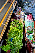 Boats loaded with fruit and vegetables to sell at the Ladmayom Floating Market near Bangkok, Thailand, September 2014.