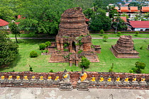 Row of Buddhas with yellow sashes at Wat Yai Chaya Mongkol, Ayutthaya, Thailand, September 2014.