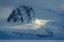 Stray light on mountains north of Spitsbergen, Svalbard, Norway, June.