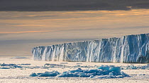 Waterfalls from the enormous glacier front Austfonna, in evening light, Svalbard, Norway, July.