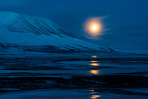 Full moon over Adventsdlen, Longyearbyen, Svalbard, Norway, April.