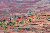 Houses in eroded landscape along the RN7 between Antsirabe and Fianarantsoa , Madagascar.