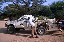 Former Save the Elephants research vehicle destroyed by bull elephant in Samburu National Reserve, Kenya. Save the Elephants workers including Iain Douglas-Hamilton trying to push start the LandCrusie...