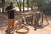 Gilbert Sabinga with radio tracking collars at the Save the Elephant camp, Samburu National Reserve, Kenya. Model Released