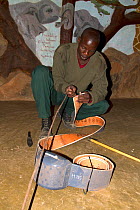 Save the Elephants employee preparing collar for elephant collaring, Samburu National Reserve, Kenya.