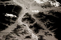 View from plane of rivers flowing through mountain valley, Saravan, South East Iran, December.