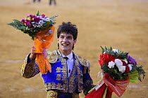 Matador with flowers after the fight, Plaza de Toros, Valencia, Spain. July 2014.